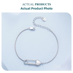 Detailed view of S925 sterling silver heart safety pin bracelet with cubic zirconia accents