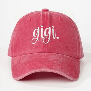 Detailed embroidery of cursive 'gigi' and heart on pink washed cotton baseball cap