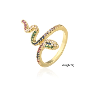 Detailed macro view of a gold snake ring with colorful cubic zirconia and 3g weight