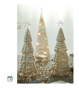 Macro detail of lighted mercury glass Christmas tree ornaments with glowing warm LED lights