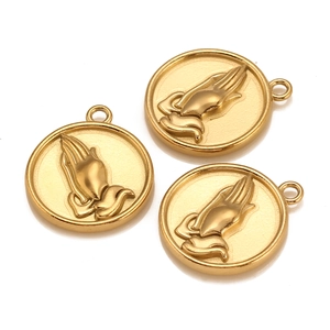 Detailed macro shot of three golden circular praying hands pendants for jewelry DIY