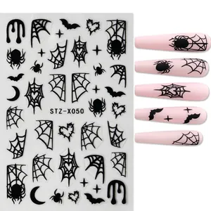 Detail of Halloween nail stickers STZ-X050 with black spiders and bats on pink nails