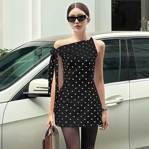 Chic black polka dot dress with stylish one-shoulder bow tie and slim fit silhouette