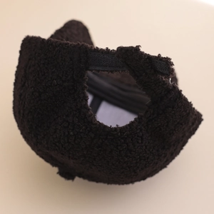 Detail of dark brown sherpa baseball cap showing adjustable strap and fuzzy texture