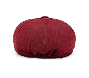 Detailed back view of a burgundy newsboy cap with elastic band and textured fabric