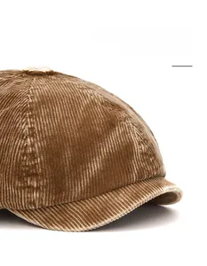 Detail of a brown corduroy newsboy cap showing the flexible and foldable brim feature