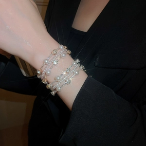 Elegant multi-layer pearl and diamond bangle with sparkling rhinestones and open design