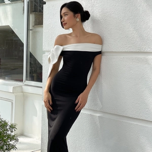 Elegant slim fit off-shoulder dress in black and white with a large white bow detail