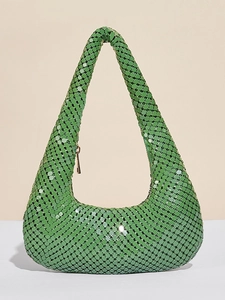 Detailed view of vibrant green metallic sequins and gold zipper on a shoulder bag