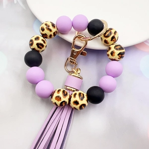 Detail of leopard print and lilac silicone beads wristlet with tassel and gold ring
