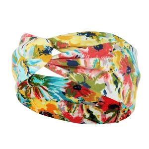 Close-up of twisted boho headband featuring vibrant colorful floral patterns on soft fabric