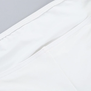 Macro shot of white knitted fabric texture and fine stitching detail on long dress
