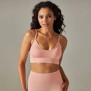 Front view of light pink seamless ribbed yoga sports bra and high waist leggings set