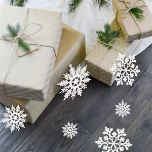 Detail of white glitter snowflakes with intricate cutout patterns for Christmas trees
