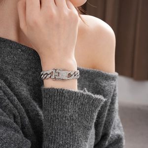 Close-up of silver punk chain bracelet with sparkling rhinestones on model's wrist