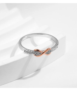 Macro view of Mobius ring with rose gold infinity symbol and sparkling pavé diamonds