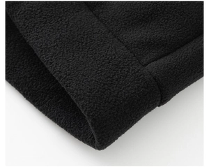 Close-up of black polar fleece texture with high-quality double-needle stitching detail