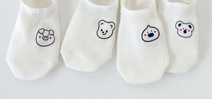 Detail view of white low cut ankle socks with cute various cartoon animal patterns