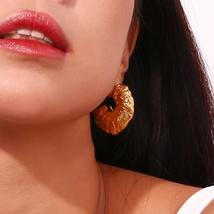 Chic 18K gold plated stainless steel hollow fan earrings with hammered texture on model