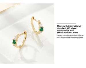 Detail shot of 925 sterling silver gold earring with S925 stamp and green gemstone