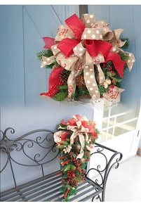 Close-up of Christmas teardrop swag with pine needles, berries, cones and metal bells