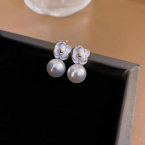 French vintage gold plated camellia earrings with white pearl detail on black jewelry box