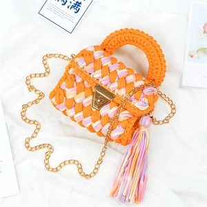 Handmade woven crossbody bag in vibrant orange with gold chain and colorful tassel