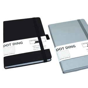 Detail view of 160-page dotted notebooks in black and gray with elastic bands