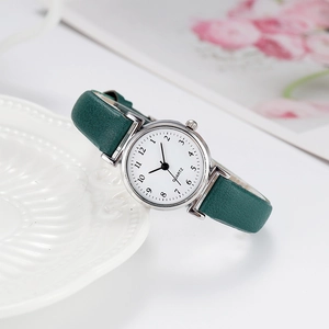 Elegant vintage women's quartz watch with dark green leather strap and silver case