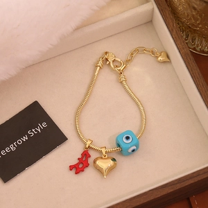Gold-plated snake chain bracelet with evil eye, red coral, and gold heart charms