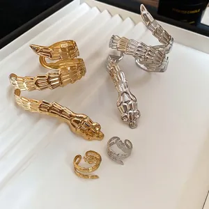 Irregular snake-shaped metal bangle and ring set with textured scale finish in gold and silver