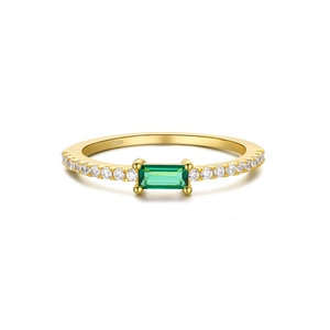 Detailed macro view of S925 hallmark on a gold-plated ring with green gemstone