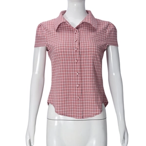 Detail of red and white plaid short-sleeved shirt with classic collar and white buttons