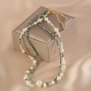 Double-layer necklace with white pearls, turquoise beads and gold-tone metal accents