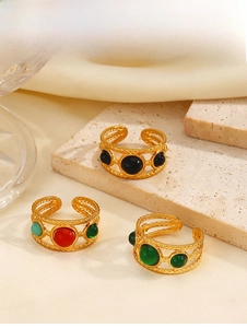 Detailed view of hollow braided gold rings with vintage colorful resin stones on stone