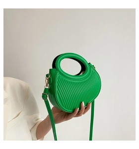 Green crescent moon shoulder bag with vertical stripes and circular handle
