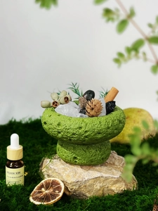 Detailed shot of green volcanic stone essential oil diffuser with crystals and dried flowers
