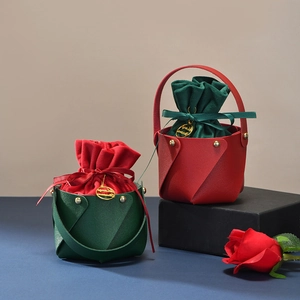 Red and green leather Christmas gift baskets with velvet pouches and gold tags