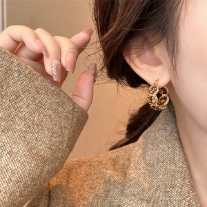 18k gold plated round crystal earrings in amber, vintage fashion style on a model