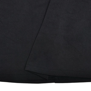 Detail of ruffle hem and fine stitching on a black mesh patchwork bodycon dress