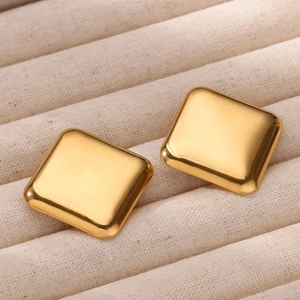 Polished 18K gold hollow square hoop earrings for women on a beige texture tray