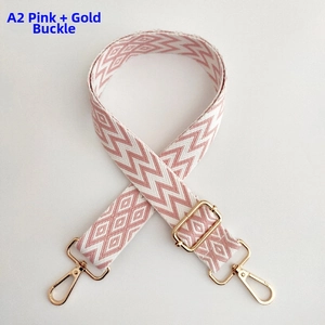Detail view of pink wave pattern woven bag strap with golden rotating metal buckles