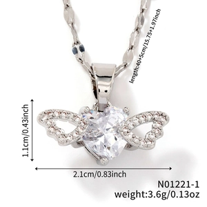 Macro shot of silver winged heart pendant with zircon showing precise 2.1x1.1cm dimensions