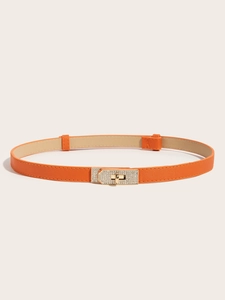 Close-up of orange Saffiano leather belt with a crystal-studded gold turn-lock buckle