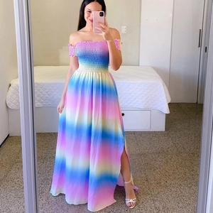 Detail of smocked bandeau bodice on rainbow gradient maxi dress with high side slit