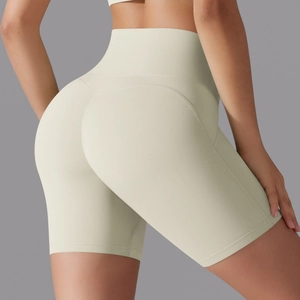 Detail of high waisted cream yoga shorts featuring heart shaped push up seams on back
