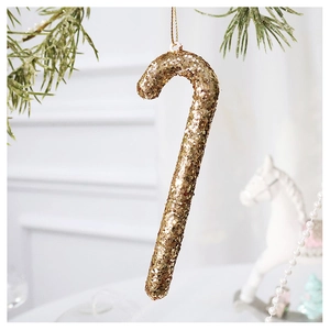 Macro shot of champagne gold glitter candy cane ornament with sparkling textured surface