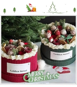 Close-up of knit texture Christmas gift boxes with pine branches and dried fruit décor