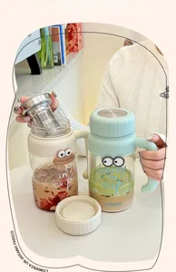 Detail of cute glass tea mugs with 304 stainless steel filters and cartoon eye design