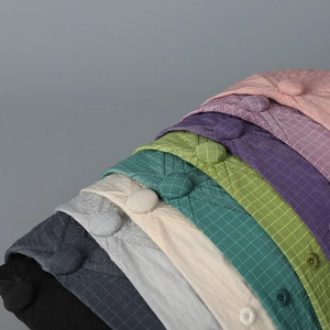 Detail of lightweight plaid baseball caps showing diamond quilting and colorful options